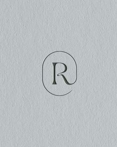 the letter r is made out of paper and has a black circle around it's edge