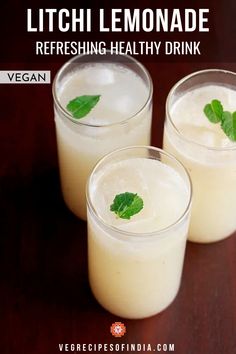 three glasses filled with lemonade on top of a wooden table