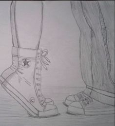 a pencil drawing of two feet with shoes on the ground next to eachother