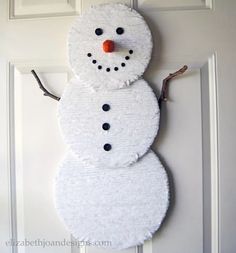 a snowman made out of toilet paper on the front door