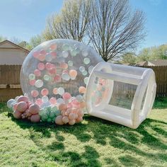 an inflatable ball and some balls on the grass