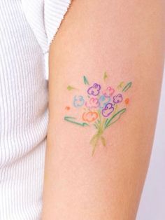 a woman with a flower tattoo on her arm