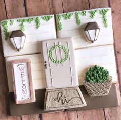 a cake decorated to look like a door and potted plants on a wooden table