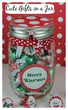 a jar filled with lots of candy sitting on top of a white table next to red and white polka dots