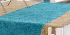 a blue and beige rug on top of a bed