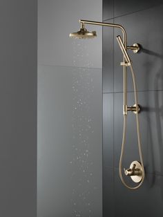 a shower head with thermostaer and hand held shower faucet in gold