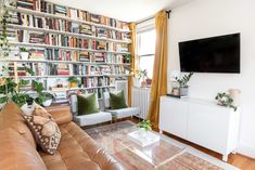 a living room filled with furniture and bookshelves