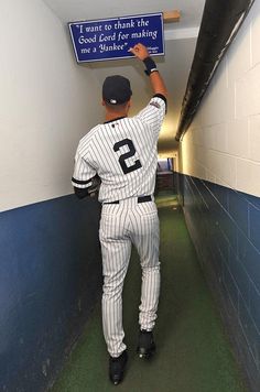 a baseball player is holding up a sign