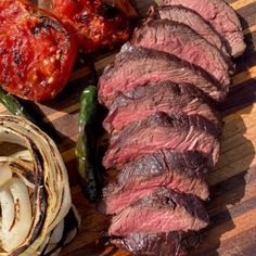 steak, onions and peppers on a cutting board