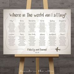 a wooden easer with a seating chart on it that says where in the world am i sitting?