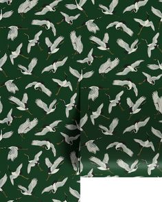 a green wallpaper with white birds on it