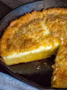 a close up of a pie in a pan on a table with a piece missing