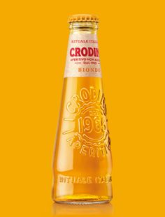 a bottle of croni's golden syrup on a yellow background with the words croni