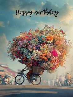 a bicycle is loaded with colorful flowers on the front and back wheels that says happy birthday