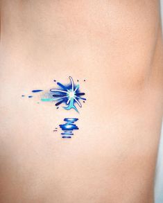 a woman's stomach with an artistic tattoo design on her left side ribcage