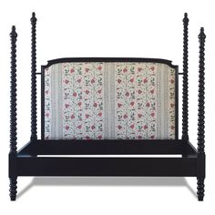 a black bed frame with four posts and flowers on the back side, against a white background