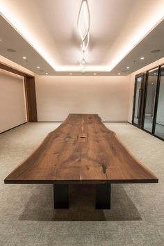 a large wooden table in an empty room