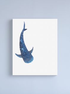 a blue bird with white spots on it's wings flying in the sky canvas print