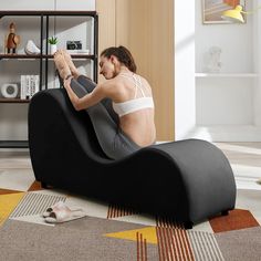 a man sitting on a bean bag chair in the middle of a living room with his feet up