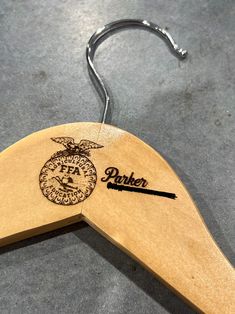 a wooden hanger with the name parker on it