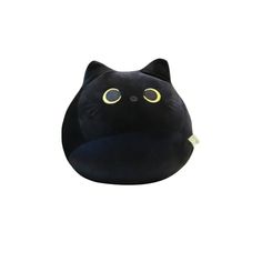 a black cat pillow sitting on top of a white surface