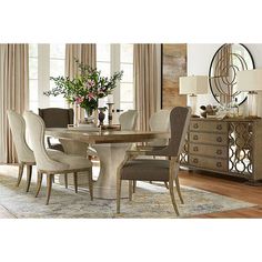 a dining room table with chairs and a mirror in the corner next to a dresser