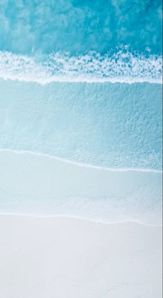 two people riding skis on top of a sandy beach