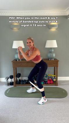 a woman is doing an exercise in the living room