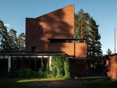 the house is made out of brick and has ivy growing on it's side