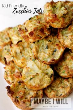 a pile of zucchini tots sitting on top of a white plate