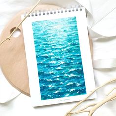 a spiral notebook sitting on top of a wooden table