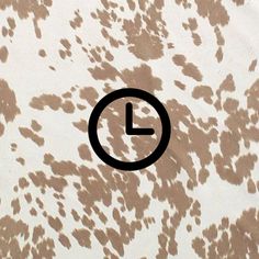 an image of a clock on a wall with spots in the middle and black circle at the center