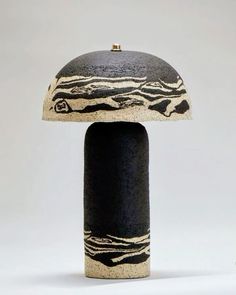 an unusual black and white object with a dome shaped top on it's base