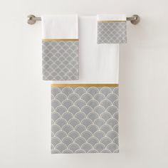 two towels hanging on the wall next to each other in front of a white wall