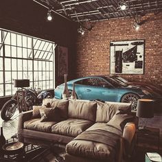 a living room filled with furniture and lots of windows next to a blue sports car