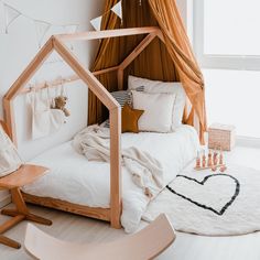 a child's room with a bed, rugs and teddy bear toys on the floor