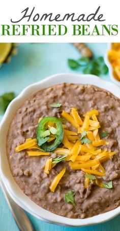 a white bowl filled with refried beans and cheese