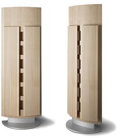 two tall wooden buildings on pedestals next to each other