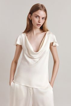 Meet Scarlett, a blouse with undeniable wow factor A soft, deep cowl neckline and delicate flutter sleeves create a statement silhouette that will add a sense of drama to any outfit Semi-fitted and bias cut in satin so it gently skims the body, add her into your repertoire for a low-effort, high-impact style you can always turn to Satin Short Sleeve, Work Fits, Satin Short, Ageless Style, Ladies Clothing, Cowl Neck Top, Cowl Neckline, Affordable Luxury, Flutter Sleeves