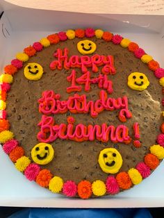 a birthday cake decorated with smiley faces and flowers in a box for someone's 44th birthday