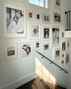 a staircase with many pictures on the wall