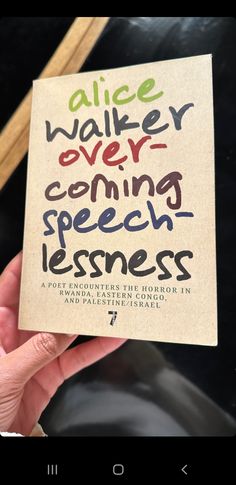 a hand holding up a piece of paper with writing on it that says alice walker is coming speechless