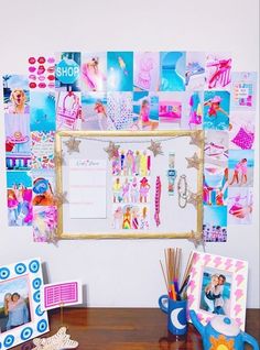 a wooden table topped with pictures and frames