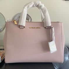 Brand New Never Used Michael Kors Soft Pink Handbag/Satchel. Comes With Strap That Can Convert Purse To Satchel. No Defects. Tag Still Attached. Perfect Condition. Stuffing Still Inside! Michael Kors Everyday Tote Satchel, Michael Kors Rectangular Satchel With Handle Drop, Michael Kors Tote Satchel For On-the-go, Michael Kors Satchel For On-the-go, Michael Kors Satchel Shoulder Bag With Handle Drop, Michael Kors Bag With Top Carry Handle For On-the-go, Michael Kors Everyday Satchel, Michael Kors Everyday Satchel With Double Handle, Michael Kors Rectangular Bag With Detachable Handle