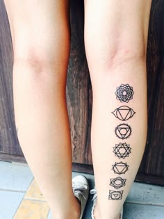 a woman's legs with tattoos on them and the words yoga written in different languages