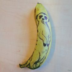 a banana with a drawing on it that looks like a slotty in the middle