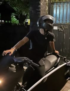 a person on a motorcycle with a helmet