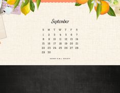 an image of a desktop calendar with oranges and flowers on the front, as well as a blackboard background