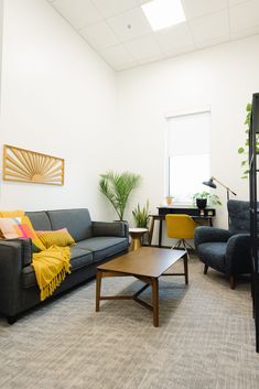 a living room filled with furniture and plants