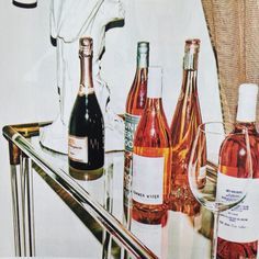 several bottles of wine are sitting on a table next to a towel and glassware